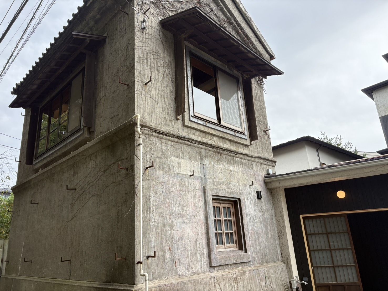 民泊として開業する2階建ての建物の外観——瓦屋根と木製の窓枠が残る(神奈川県鎌倉市)
